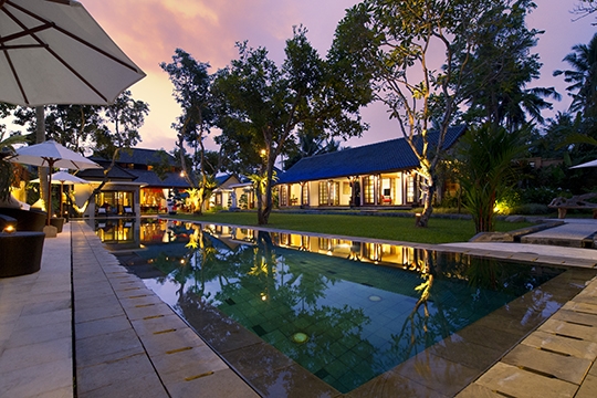 Pool and villa at dusk